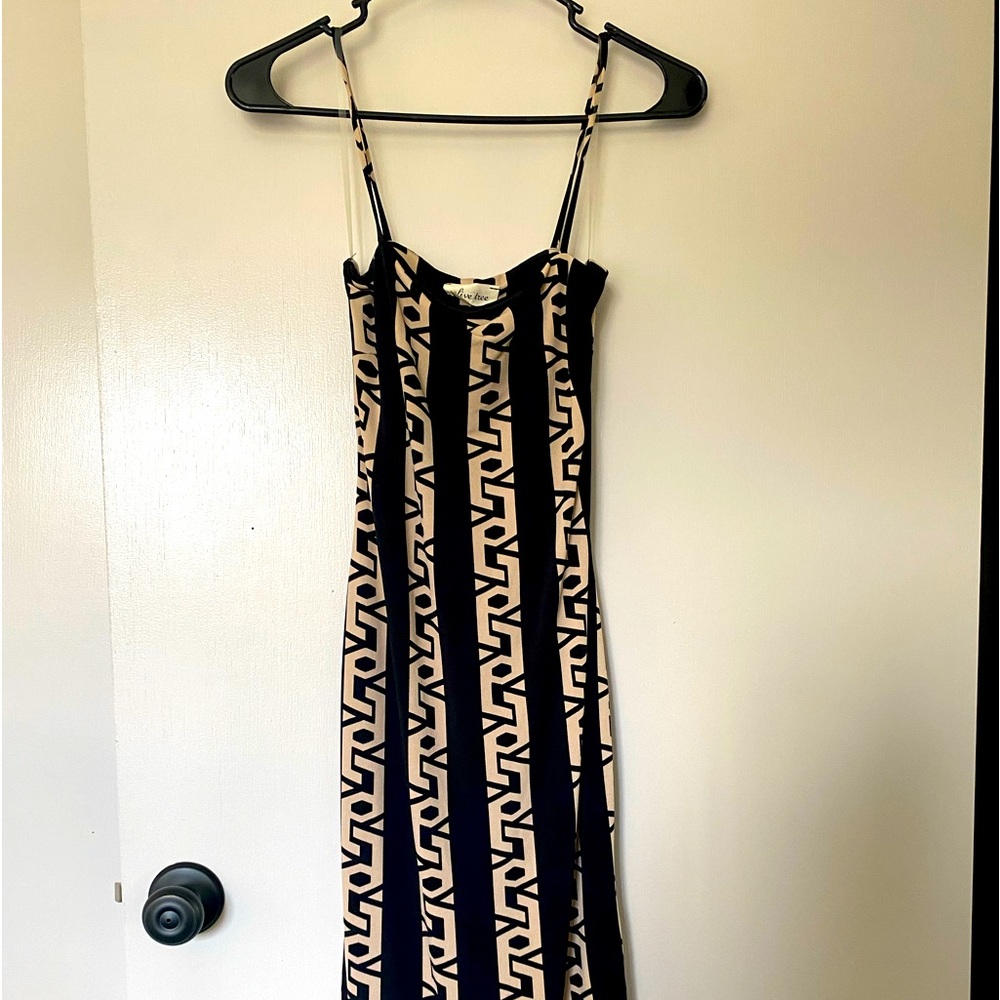 Spaghetti strap, Black cocktail length dress. Tan design.